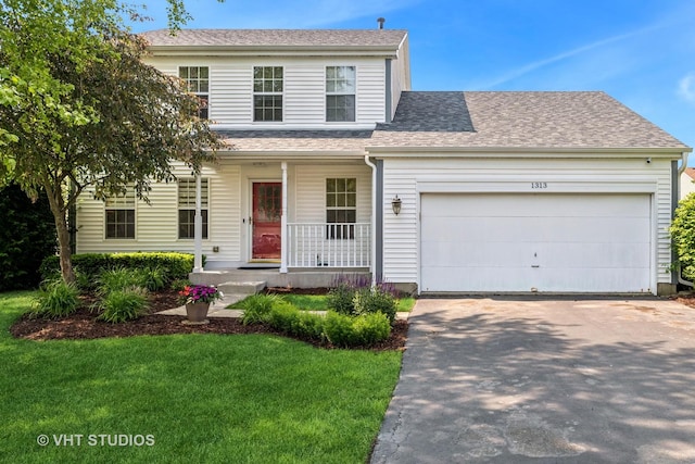 1313 Edington Ln, Mundelein, IL 60060 - view of front of house featuring a porch, concrete driveway, an attached garage, a front lawn, and roof with shingles