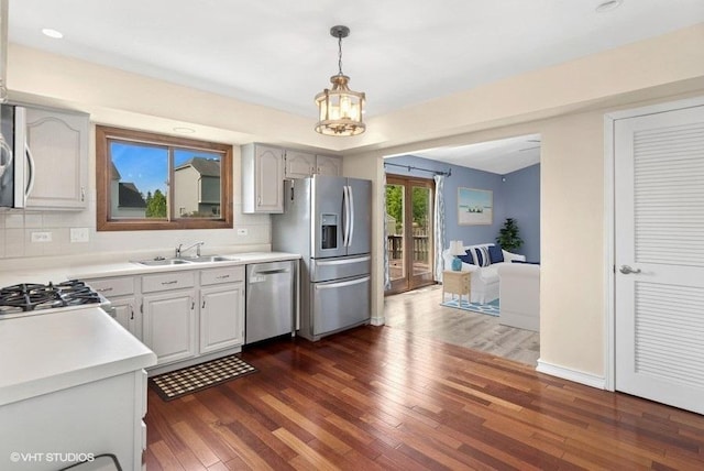 1313 Edington Ln, Mundelein, IL 60060 - kitchen with appliances with stainless steel finishes, dark wood-style floors, light countertops, and pendant lighting