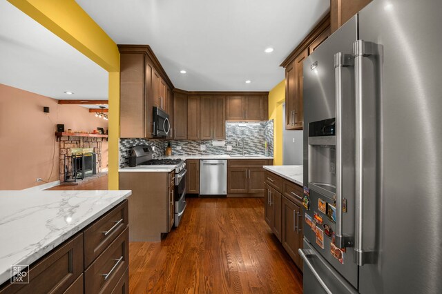 12732 S Austin Ave, Palos Heights, IL 60463 - kitchen featuring stainless steel appliances, dark wood-style flooring, backsplash, light stone countertops, and a sink