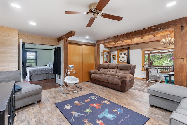 20425 N Hazelcrest Rd, Palatine, IL 60074 - living room with a ceiling fan, recessed lighting, light wood-style flooring, a chandelier, and wooden walls