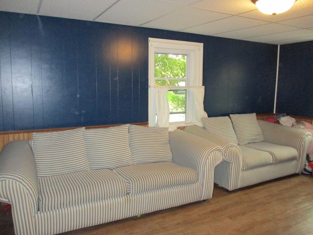 411 S Walnut St, Forreston, IL 61030 - living area with wood finished floors, a paneled ceiling, and wooden walls