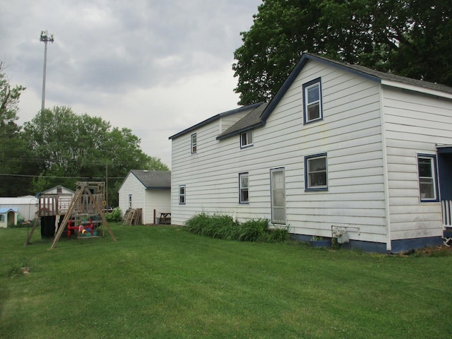 411 S Walnut St, Forreston, IL 61030 - rear view of property featuring a playground and a lawn