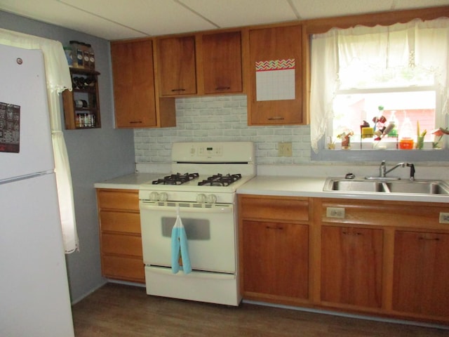 411 S Walnut St, Forreston, IL 61030 - kitchen featuring white appliances, a sink, light countertops, brown cabinets, and tasteful backsplash
