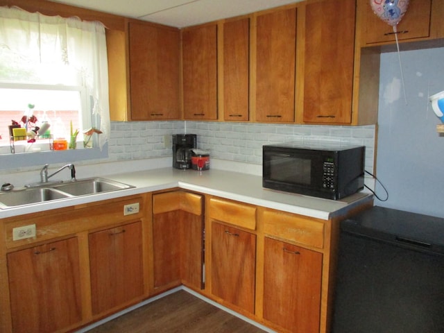 411 S Walnut St, Forreston, IL 61030 - kitchen with black microwave, a sink, light countertops, brown cabinets, and dark wood-type flooring