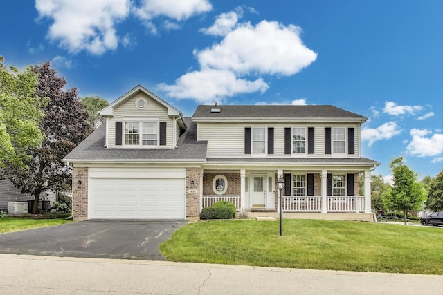 1492 Della Dr, Hoffman Estates, IL 60169 - view of front facade featuring asphalt driveway, covered porch, a front lawn, brick siding, and a garage
