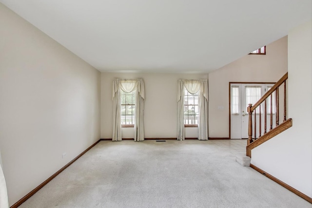1492 Della Dr, Hoffman Estates, IL 60169 - unfurnished living room featuring light colored carpet and stairs