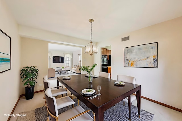 1492 Della Dr, Hoffman Estates, IL 60169 - dining room featuring light colored carpet and a chandelier