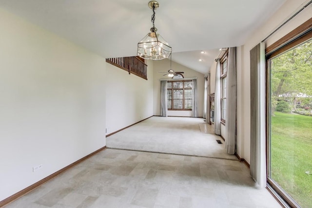 1492 Della Dr, Hoffman Estates, IL 60169 - empty room with a chandelier, healthy amount of natural light, lofted ceiling, a ceiling fan, and carpet flooring