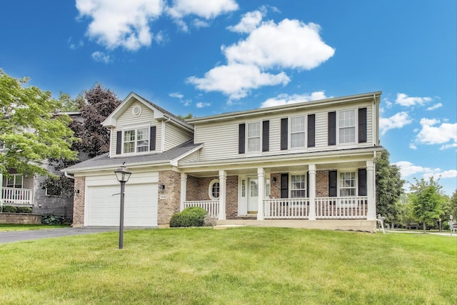 1492 Della Dr, Hoffman Estates, IL 60169 - view of front of home with covered porch, asphalt driveway, a garage, a front yard, and brick siding