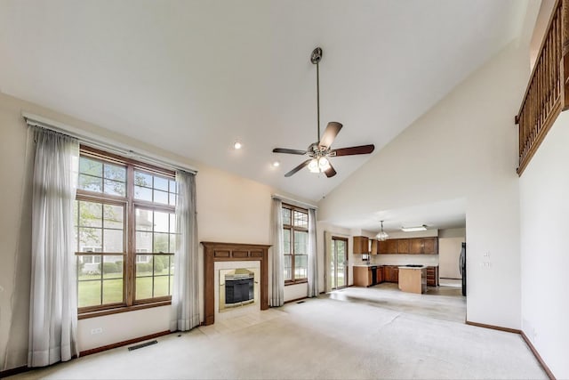 1492 Della Dr, Hoffman Estates, IL 60169 - unfurnished living room with healthy amount of natural light, light colored carpet, a fireplace, high vaulted ceiling, and ceiling fan