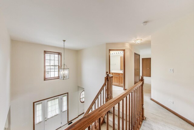 1492 Della Dr, Hoffman Estates, IL 60169 - hall featuring an upstairs landing, a chandelier, and light carpet