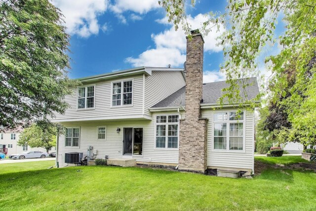 1492 Della Dr, Hoffman Estates, IL 60169 - back of property with a chimney and a yard