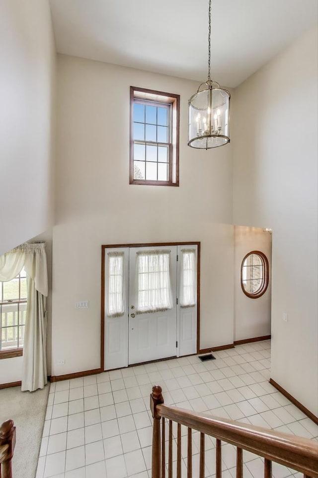 1492 Della Dr, Hoffman Estates, IL 60169 - foyer with a towering ceiling, a chandelier, and light tile patterned flooring
