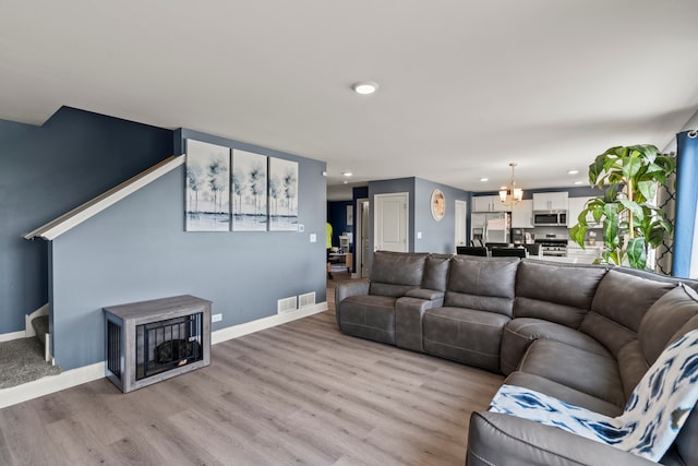 6012 Winterhaven Dr, Joliet, IL 60431 - living room with light wood-style flooring, recessed lighting, and a chandelier