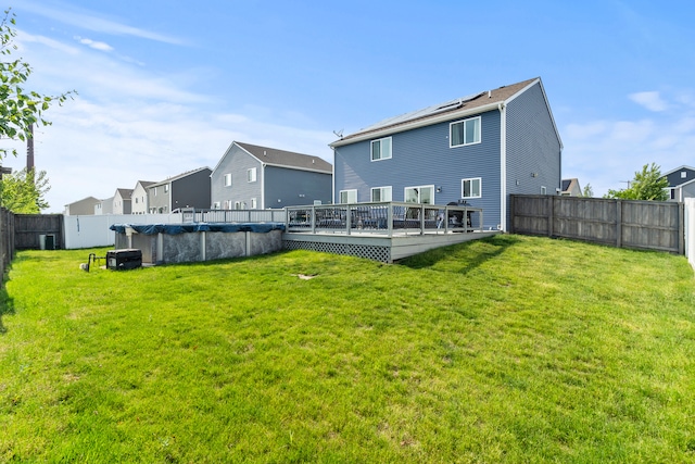 6012 Winterhaven Dr, Joliet, IL 60431 - back of property featuring a fenced backyard, a deck, and a residential view