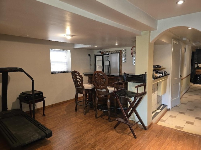 3933 N Oak Park Ave, Chicago, IL 60634 - indoor dry bar featuring arched walkways, light wood-style flooring, fridge, baseboards, and recessed lighting