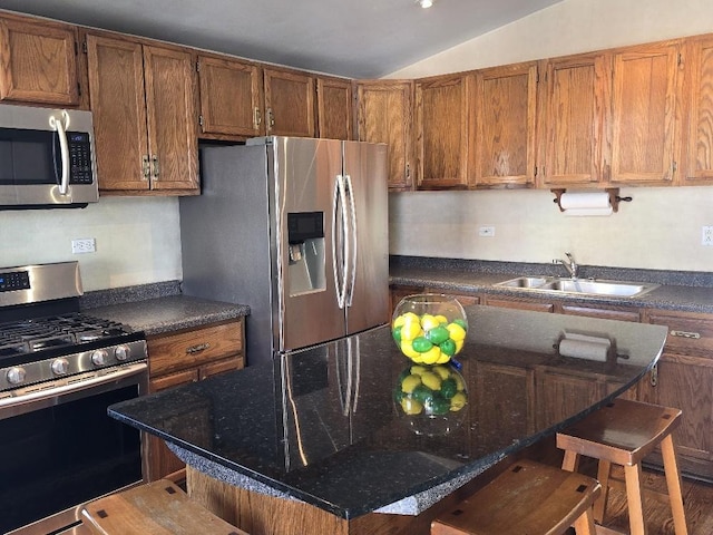 3933 N Oak Park Ave, Chicago, IL 60634 - kitchen featuring stainless steel appliances, a sink, lofted ceiling, a breakfast bar, and a kitchen island