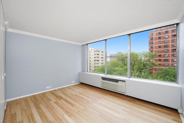 5757 N Sheridan Rd Unit 5J, Chicago, IL 60660 - spare room featuring crown molding, a wall unit AC, wood finished floors, and baseboards