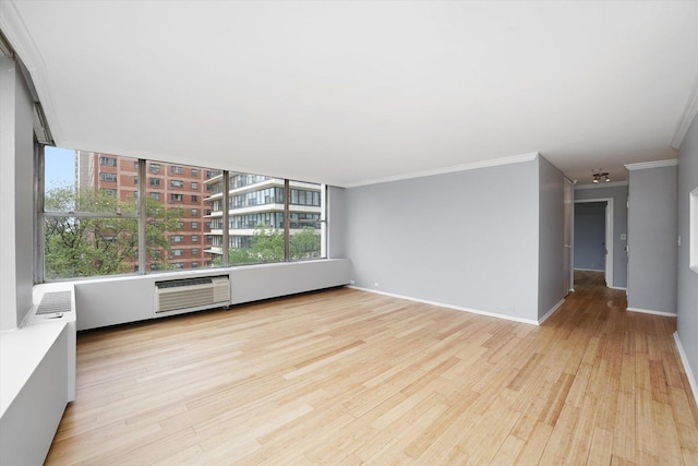 5757 N Sheridan Rd Unit 5J, Chicago, IL 60660 - empty room featuring crown molding, wood finished floors, baseboards, and a wall unit AC