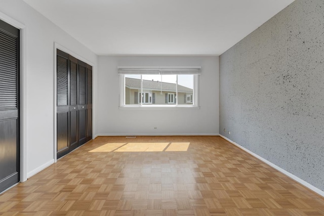 326 Dorchester Ln, Elk Grove Village, IL 60007 - unfurnished bedroom featuring baseboards and multiple closets