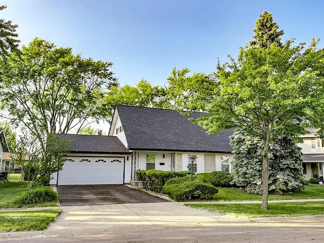 326 Dorchester Ln, Elk Grove Village, IL 60007 - view of front of house featuring an attached garage, concrete driveway, roof with shingles, and a front yard