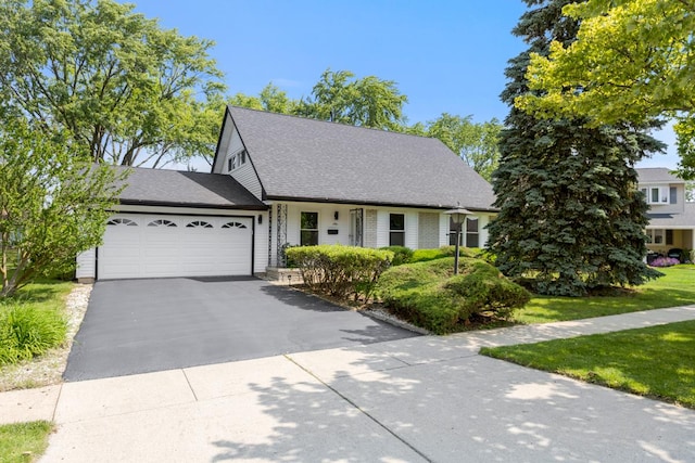 326 Dorchester Ln, Elk Grove Village, IL 60007 - view of front facade with an attached garage, asphalt driveway, and a front lawn