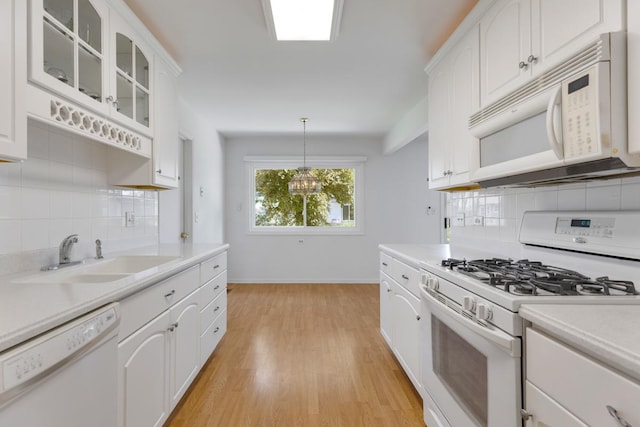 326 Dorchester Ln, Elk Grove Village, IL 60007 - kitchen featuring white appliances, backsplash, light wood-style flooring, light countertops, and glass insert cabinets