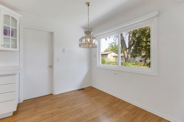 326 Dorchester Ln, Elk Grove Village, IL 60007 - unfurnished dining area with a chandelier and light wood finished floors