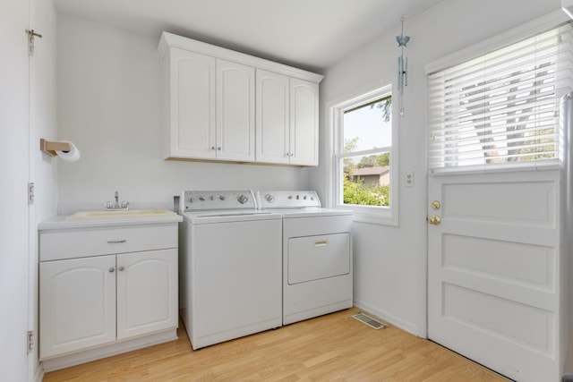 326 Dorchester Ln, Elk Grove Village, IL 60007 - laundry area featuring separate washer and dryer, light wood-style flooring, and cabinet space