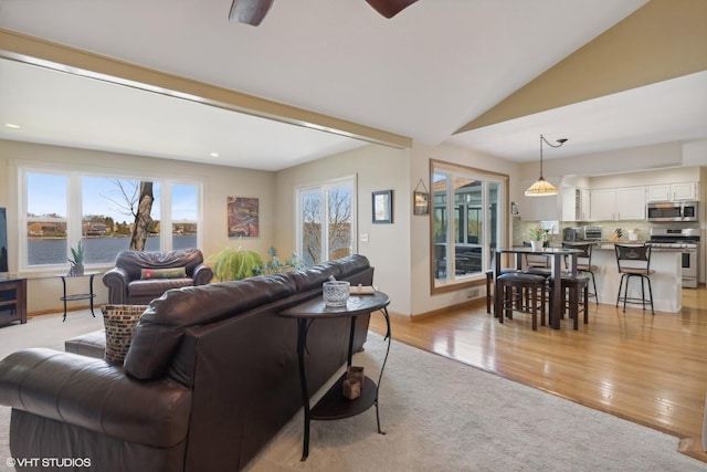 2212 High Point Dr, Lindenhurst, IL 60046 - living area featuring vaulted ceiling, light wood-type flooring, baseboards, and ceiling fan