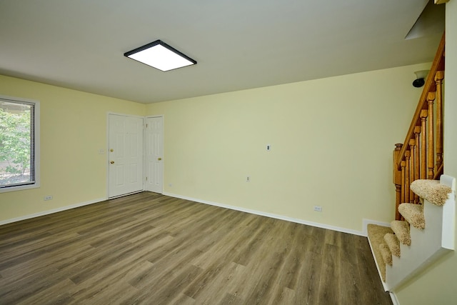 6256 Kit Carson Dr Unit 6256, Hanover Park, IL 60133 - spare room with wood finished floors, baseboards, and stairs
