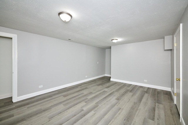 6256 Kit Carson Dr Unit 6256, Hanover Park, IL 60133 - finished below grade area featuring wood finished floors, baseboards, and a textured ceiling