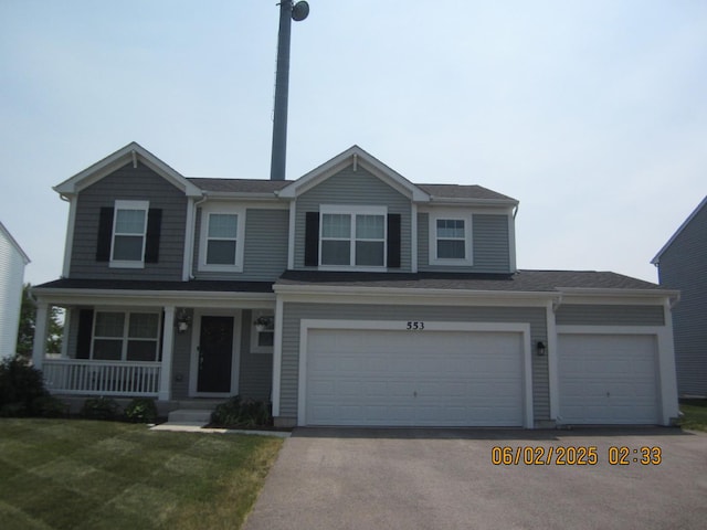 553 Hemmingsen St, Plano, IL 60545 - view of front of home featuring a porch, driveway, a front lawn, and a garage