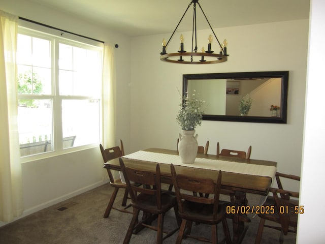 553 Hemmingsen St, Plano, IL 60545 - carpeted dining area with a chandelier and baseboards