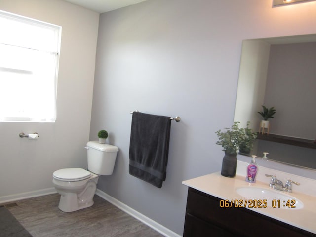 553 Hemmingsen St, Plano, IL 60545 - half bath with plenty of natural light, wood finished floors, toilet, and vanity