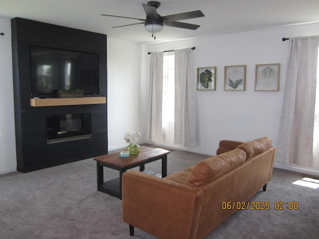 553 Hemmingsen St, Plano, IL 60545 - carpeted living room featuring a ceiling fan and baseboards