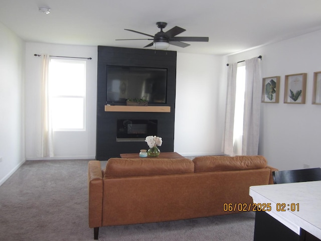553 Hemmingsen St, Plano, IL 60545 - carpeted living room featuring a ceiling fan and baseboards