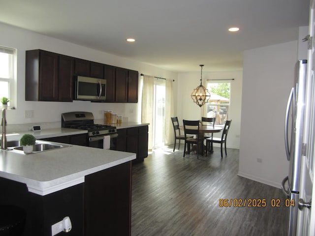 553 Hemmingsen St, Plano, IL 60545 - kitchen with appliances with stainless steel finishes, a sink, light countertops, dark wood-style floors, and recessed lighting