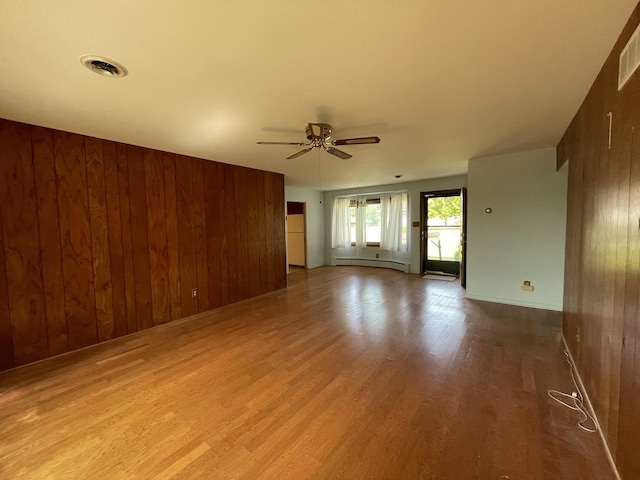 2009 Boehme St, Lockport, IL 60441 - unfurnished room with wooden walls, ceiling fan, wood finished floors, and baseboard heating