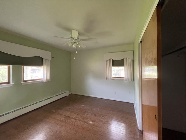 2009 Boehme St, Lockport, IL 60441 - spare room with baseboard heating, wood finished floors, a ceiling fan, and baseboards