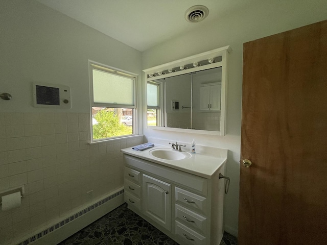 2009 Boehme St, Lockport, IL 60441 - bathroom featuring a baseboard radiator, vanity, a wainscoted wall, and tile walls