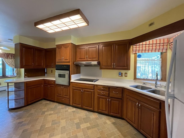 2009 Boehme St, Lockport, IL 60441 - kitchen featuring oven, a sink, freestanding refrigerator, under cabinet range hood, and light countertops
