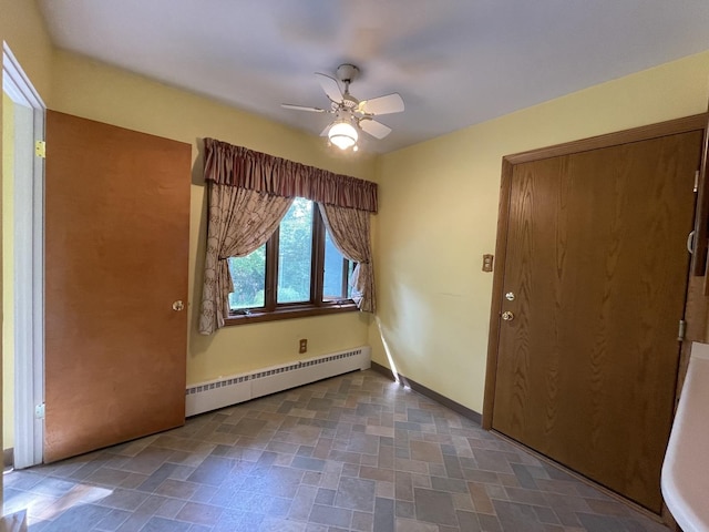 2009 Boehme St, Lockport, IL 60441 - empty room featuring a baseboard radiator, a ceiling fan, stone finish flooring, and baseboards