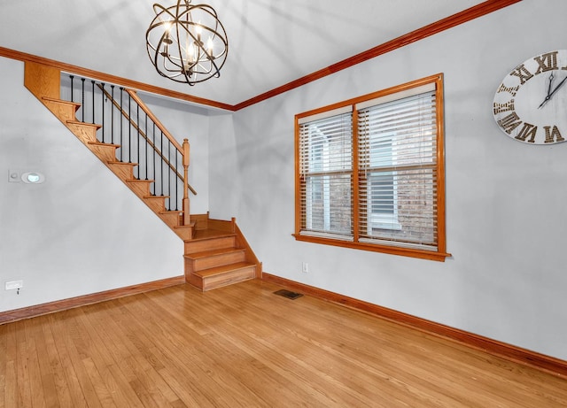 2822 N 76th Ct, Elmwood Park, IL 60707 - unfurnished living room featuring baseboards, ornamental molding, hardwood / wood-style floors, a chandelier, and stairs