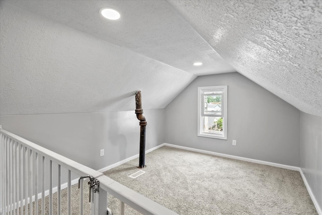 752 N 9th Ave, Kankakee, IL 60901 - additional living space with a textured ceiling, carpet flooring, vaulted ceiling, and baseboards
