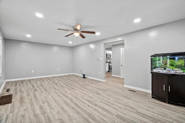 752 N 9th Ave, Kankakee, IL 60901 - unfurnished living room with a ceiling fan, recessed lighting, light wood-style floors, and baseboards