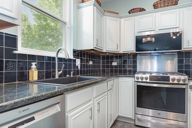 3518 Matisse Dr, Saint Charles, IL 60175 - kitchen featuring appliances with stainless steel finishes, white cabinetry, decorative backsplash, and dark stone counters