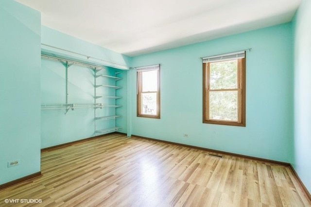 1029 Rain Tree Dr, Bolingbrook, IL 60440 - unfurnished bedroom featuring wood finished floors and a closet