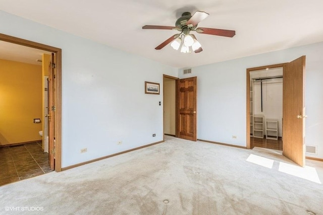 1029 Rain Tree Dr, Bolingbrook, IL 60440 - unfurnished bedroom with a walk in closet, carpet flooring, a closet, ensuite bath, and ceiling fan