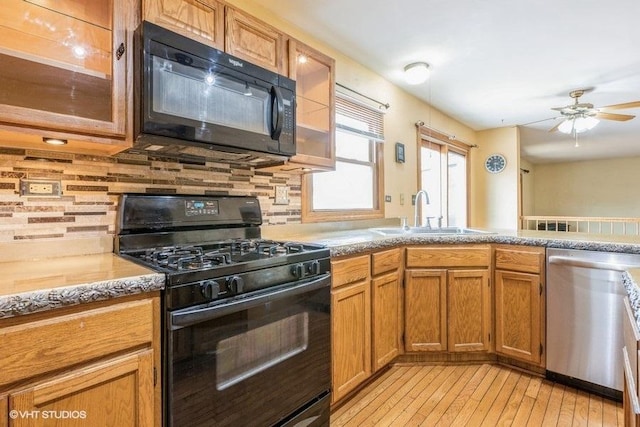 1029 Rain Tree Dr, Bolingbrook, IL 60440 - kitchen featuring black appliances, ceiling fan, light wood-style flooring, and glass insert cabinets